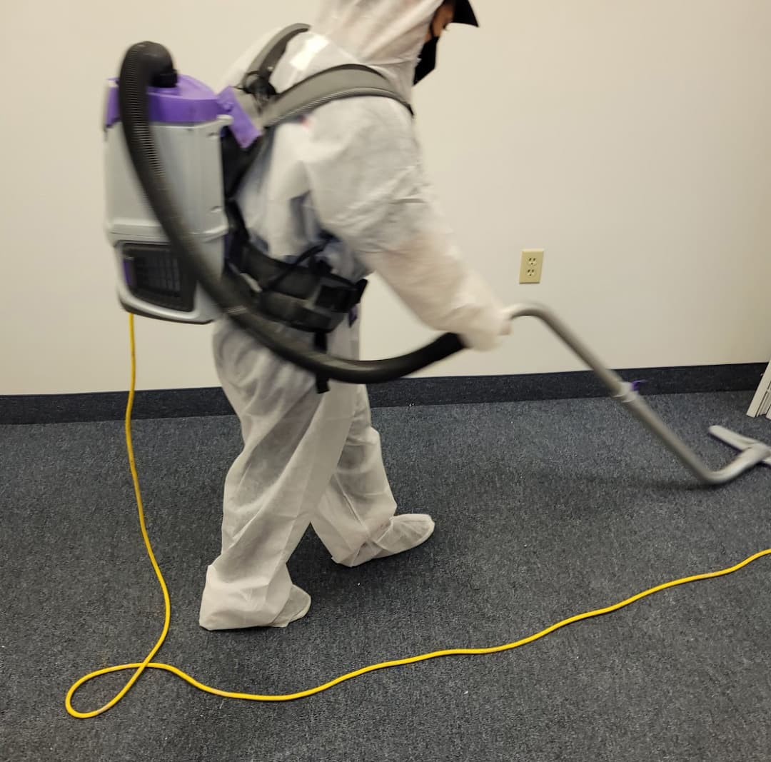 IICRC-certified mold remediation technician performing HEPA vacuuming to remove settled spores and fine particulate during professional mold cleanup in Monmouth County, New Jersey home.