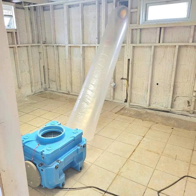 IICRC-compliant HEPA 500 air scrubber ducted outside to establish a negativr air containment and continuous air filtration during professional mold remediation in a Monmouth County, New Jersey home